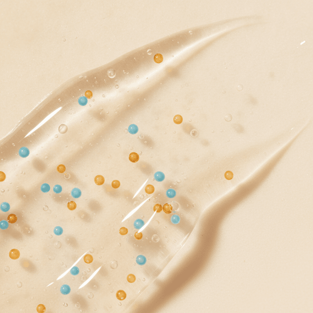 Clear cleansing gel with suspended blue and amber jojoba beads